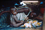 49. Sassandra sitting next to sleeping mother, Tahan